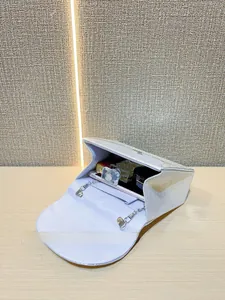 Silver sequin clutch bag interior showing space for phone and cosmetics with metal chain