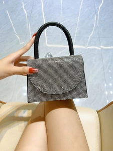 Detail of luxury mini handbag with silver rhinestones and a matte black handle