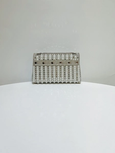 Detailed close-up of pearl and rhinestone clutch evening bag with silver metal accents