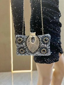 Detailed shot of luxury silver evening clutch with black crystal sunburst rhinestones