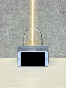 Detail view of mini rhinestone handbag with silver metal handle for evening wear