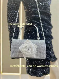 Detail of silver rhinestone evening bag with floral design and detachable chain strap
