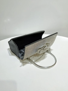 Detail of silver rhinestone evening bag with floral rose decor and black silk interior