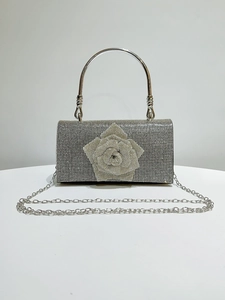 Silver evening clutch with crystal flower detail, metal handle and detachable chain strap