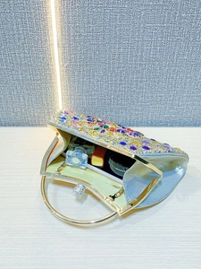 Detailed interior view of a luxury crystal evening clutch with colorful rhinestones
