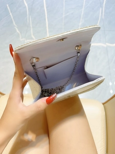 Silver glitter evening clutch bag with metallic chain strap and purple lining