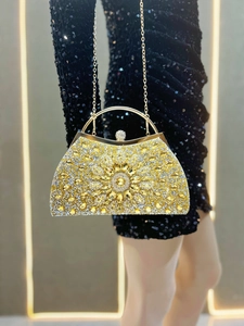 Detail of elegant gold evening clutch with radiating rhinestones and circular handle