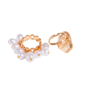 Baroque hollow gold ring set with white pearls and irregular textured band on white background