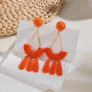 Bohemian orange woven earrings with geometric pendants and tassel charms on white stones