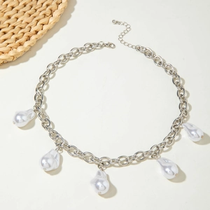 Close-up of thick silver chain necklace with five teardrop pearl pendants and lobster clasp