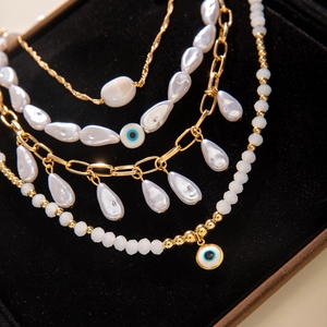 Bohemian multilayer gold chain necklace with evil eye and faux pearl pendants