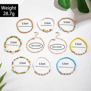 Detail of 9-piece bohemian colorful beaded bracelets set with evil eye and pearl charms