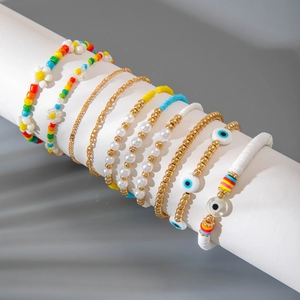 Bohemian multi-layer evil eye beaded bracelet set with colorful seed beads and gold accents