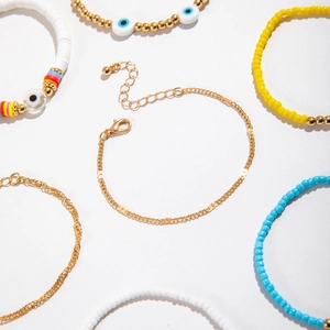 Detailed flat lay of Bohemian evil eye beaded bracelet set with gold chain and lobster clasp