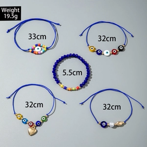 Detail view of 5-piece bohemian set showing blue evil eye, heart charm, and colorful beads