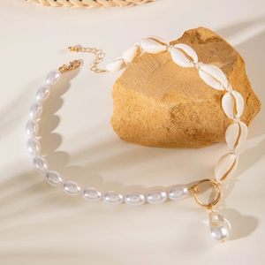 Baroque pearl necklace with seashell details on a stone, bohemian vacation style accessory