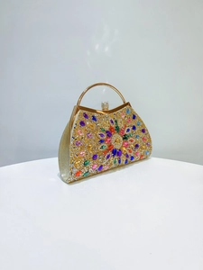 Macro detail of the luxury evening clutch showing colorful rhinestones and floral pattern
