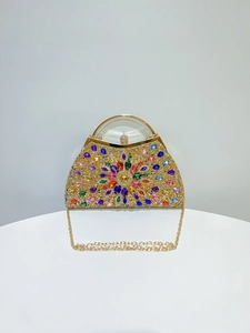 Detail shot of shimmering multi-colored rhinestones and crystals on a gold evening bag