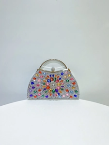 Detailed close-up of a luxury silver evening clutch featuring vibrant colorful crystal patterns
