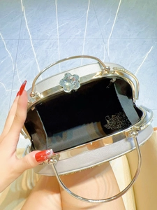 Silver evening clutch bag with peacock diamond clasp and metal ring handle