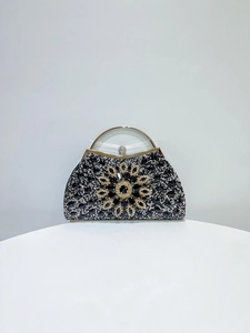 Detailed close-up of sparkling rhinestone flower pattern and metallic ring handle