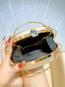Elegant gold evening clutch with crystal flower clasp and dual metal handles