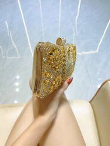 Elegant gold rhinestone evening clutch bag with floral gemstone patterns and metal handle