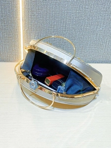 Detail of elegant sparkling evening bag interior with luxury rhinestone bracelet handles