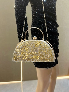 Detailed macro view of luxurious gold evening bag with intricate rhinestone floral patterns