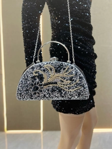 Close-up of luxury semi-circle evening clutch with intricate floral rhinestone patterns
