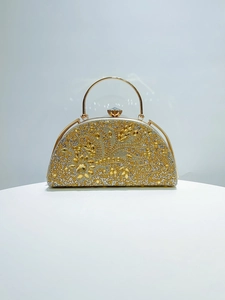 Detail of evening clutch featuring intricate floral rhinestone patterns and metal handle