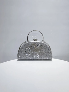 Detail of silver glitter evening clutch bag with sparkling crystal flower decoration
