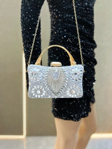 Detailed macro of silver rhinestones and crystals on a luxury evening clutch bag