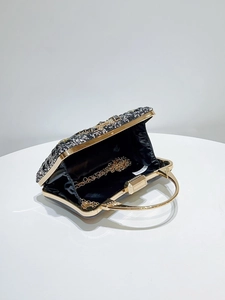 Detail of beaded evening bag with gold metal frame, sequins, and chain strap inside