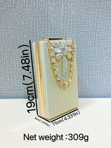 Elegant gold glitter evening clutch with rhinestone floral buckle and chain strap