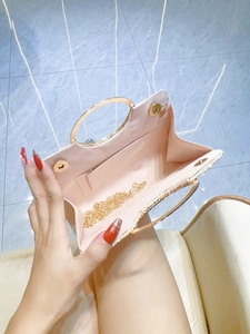 Pleated evening clutch bag with gold ring handle and chain strap in soft pink