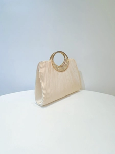 Detail of elegant pleated satin evening clutch with sparkling rhinestone metal ring handle