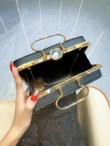 Elegant black evening clutch with gold metal trim, crystal clasp and chain strap
