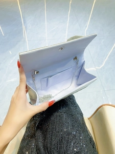 Elegant silver sequined evening clutch bag with metal chain strap and magnetic closure