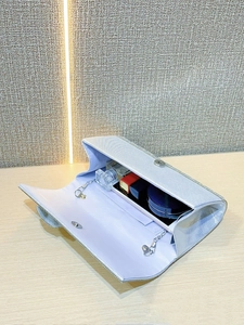 Silver glitter evening clutch showing interior space for phone, lipstick, and perfume