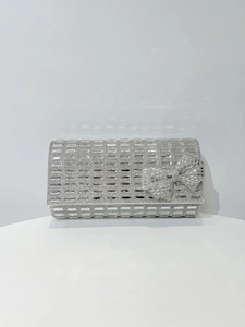 Macro view of silver rhinestone evening clutch with a sparkling crystal bow decoration