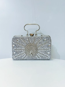 Detailed view of peacock relief and crystal rhinestones on the silver evening clutch bag