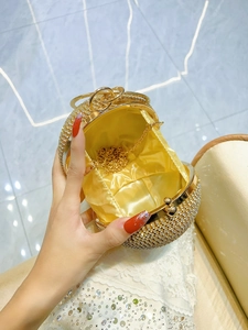 Luxurious gold evening clutch bag with sparkling rhinestones and delicate metal chain