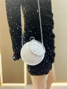 Macro detail of sphere evening clutch bag with silver rhinestones and metal ring handle