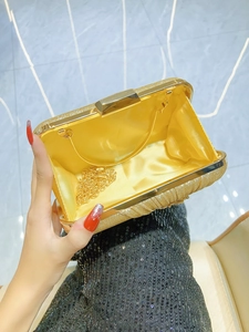 Golden sequin evening clutch bag with chain strap and bright yellow satin lining