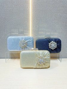 Sparkling rhinestone evening clutch bags in gold and blue with crystal flower brooches