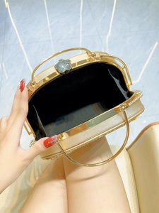 Elegant gold rhinestone evening clutch bag with sparkling flower clasp and double handles