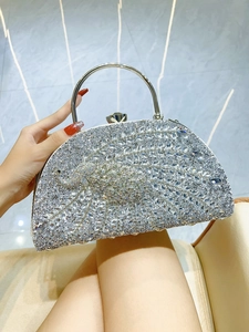 Exquisite peacock pattern detail on a silver evening clutch bag with sparkling rhinestones