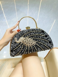 Detail of evening clutch with sparkling peacock pattern and rhinestone beadwork