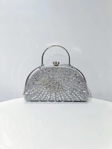 Detailed view of silver crescent evening bag with floral rhinestone patterns and round handle